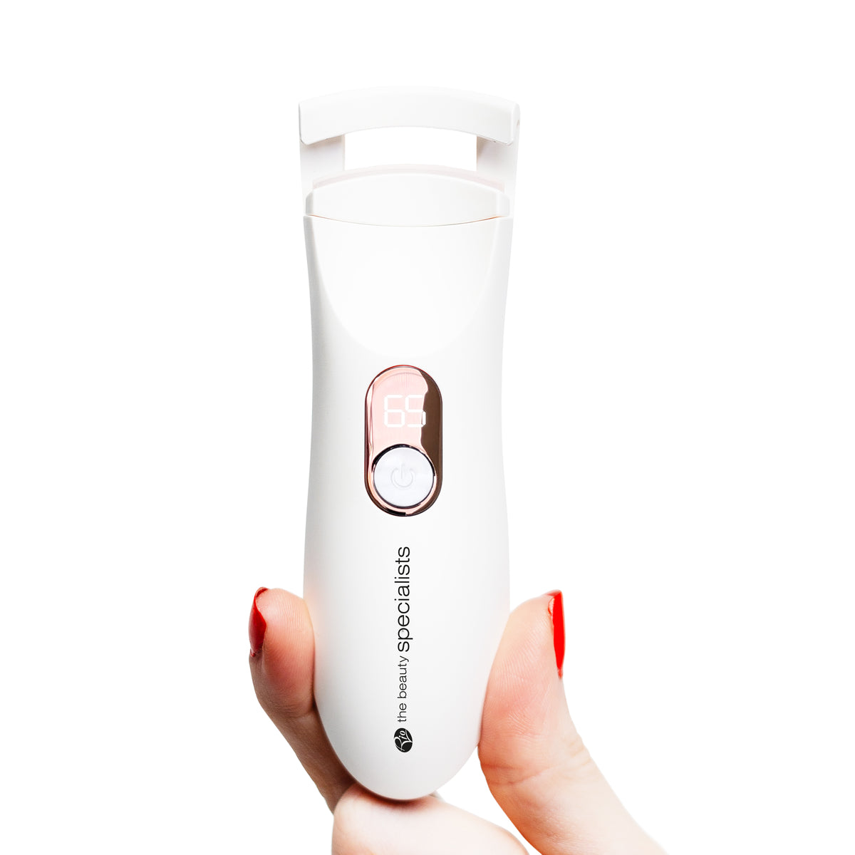 A hand holding the Heated Eyelash Curler, illustrating its compact and portable size. The device’s temperature is set to 65°C on the digital display, and the sleek white body is highlighted, showcasing its user-friendly design.