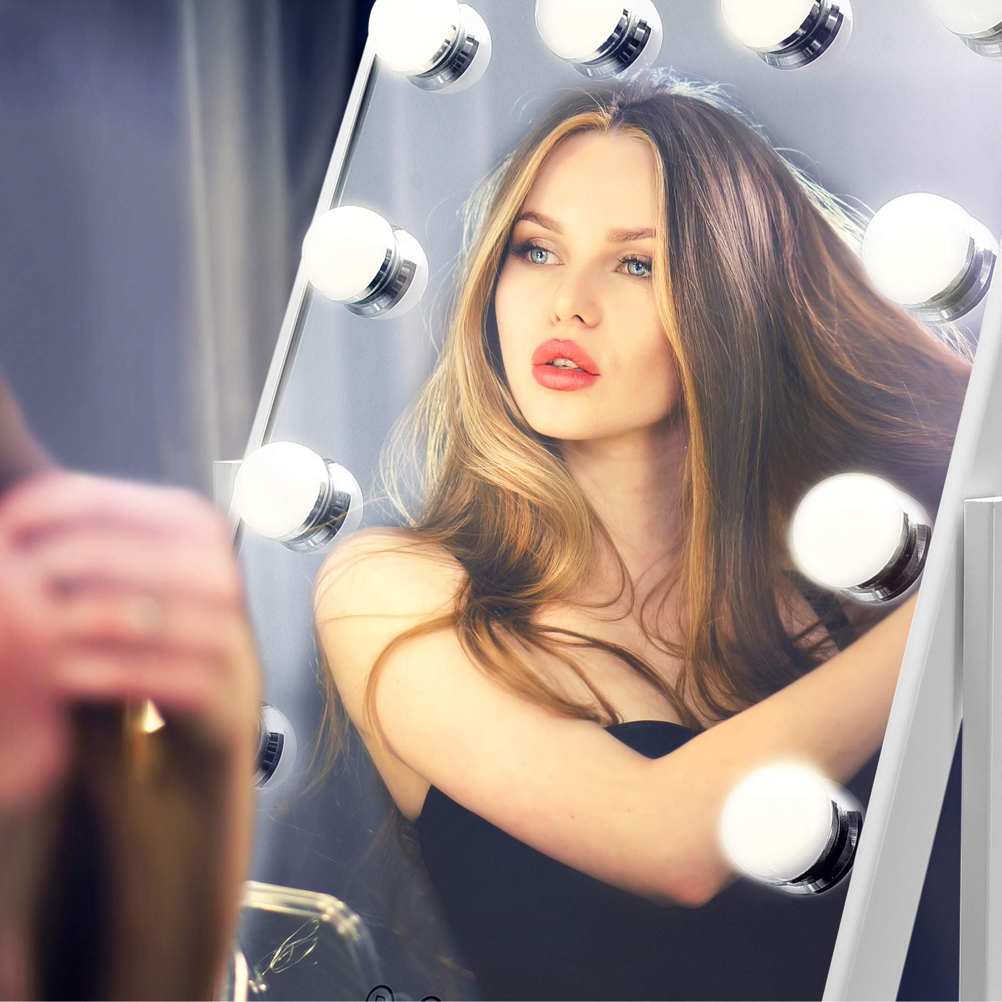 hollywood glamour mirror being used by lady doing her hair in dressing room with LED lights illuminated